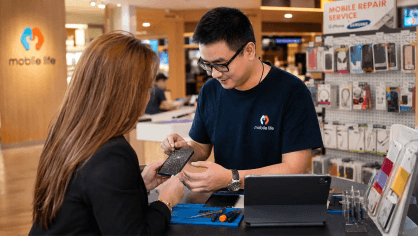 A Mobile Life technician serving a customer at the Queenstown service centre